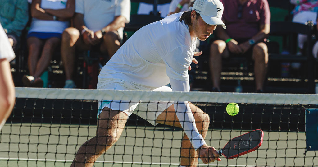Pickleball player executing a soft reset at the kitchen line